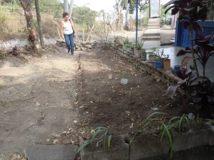 My counterpart checks out the area where we will make our garden. They graciously decided to move some plants they already had here so we can make a vegetable garden!