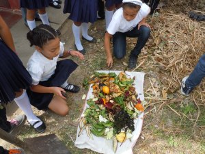 5th graders chopping veggie "trash" for the compost pile