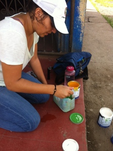 My PCV friend, Ellen, mixing paint for her World Map project