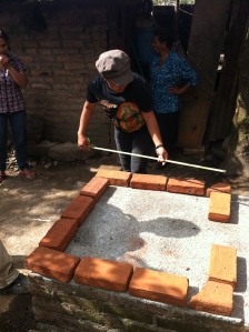 My local counterpart, Anita, measuring the base for the oven