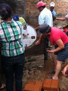The beneficiaries getting their hands dirty and learning how to build the ovens.